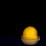 yellow safety hat on black surface